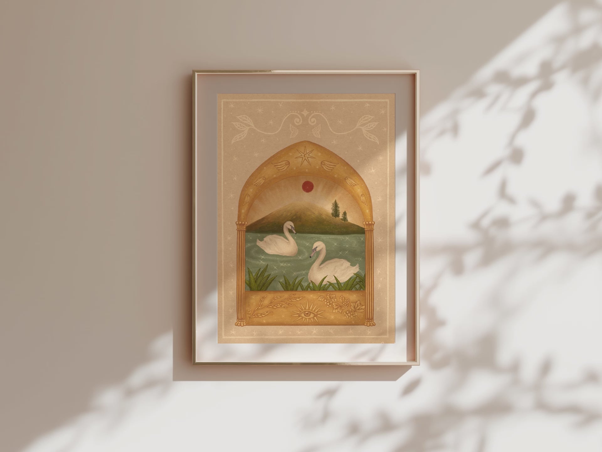 Video of framed fine art print of two white swans on a teal sparkly lake under a red moon and a golden arch. Angel wings and stars above and grape vines and an eye below.